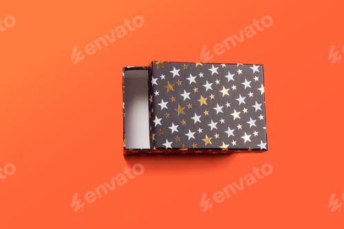 Preview: Black gift box with stars on orange coral