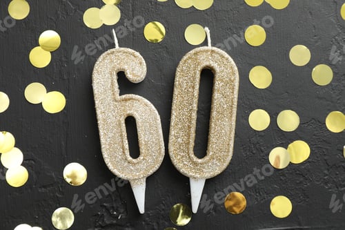 Preview: 60th birthday. Number shaped candles and confetti on black background, flat lay
