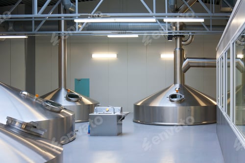 Preview: Interior of brewery, large steel storage tanks for brewing beer.