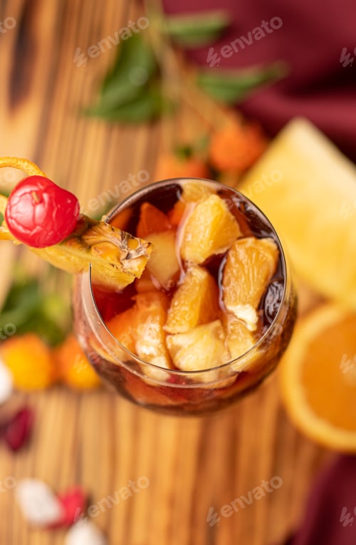Preview: Vertical shot of a delicious citrus cocktail on a wooden table