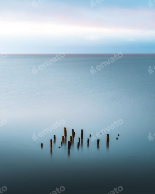 Preview: View of wooden breakwaters in a sea fog