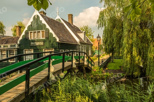 Preview: Small wooden bridge leading to a traditional rural house in the Netherlands
