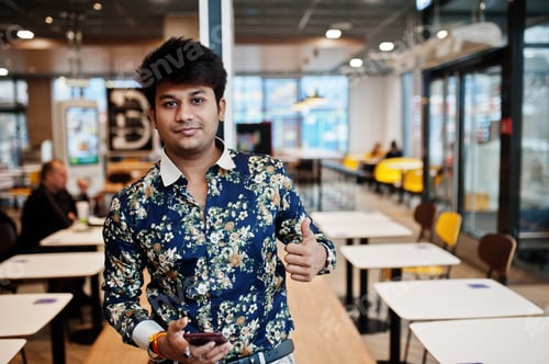 Preview: Indian man at fast food cafe