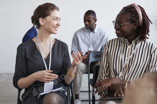 Preview: Young Businesswomen Chatting at Conference