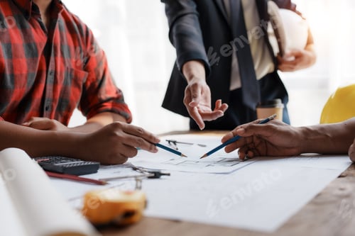 Preview: Consulting architect and engineer to discuss work, pointing to house plans to make changes