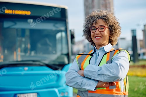 Preview: Portrait of confident female bus driver at the station looking at camera.