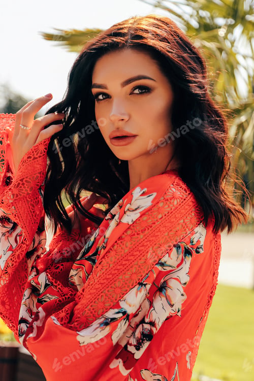 Preview: Fashion Outdoor Photo Of Beautiful Woman With Dark Hair In Elegant Red Dress Posing In The Spring