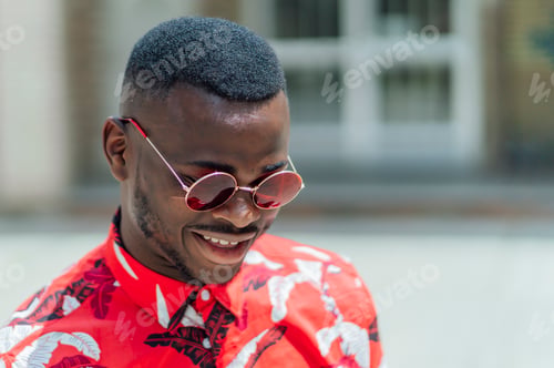 Preview: Black skinned man with red colored sunglasses