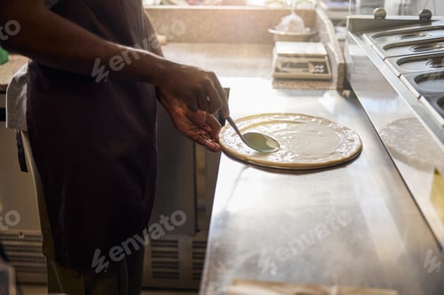 Preview: Male is making pizza in professional kitchen