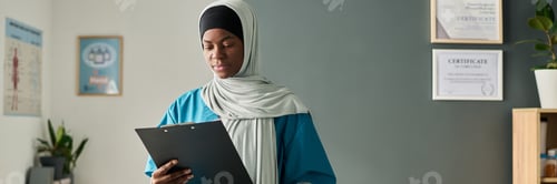 Preview: Professional Muslim Woman in Hijab Analyzing Document