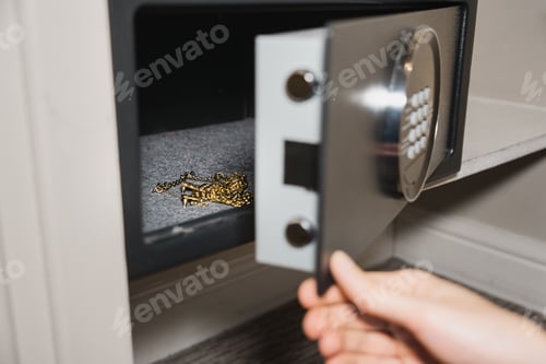 Preview: Gold Jewelry Stored Inside Open Safe