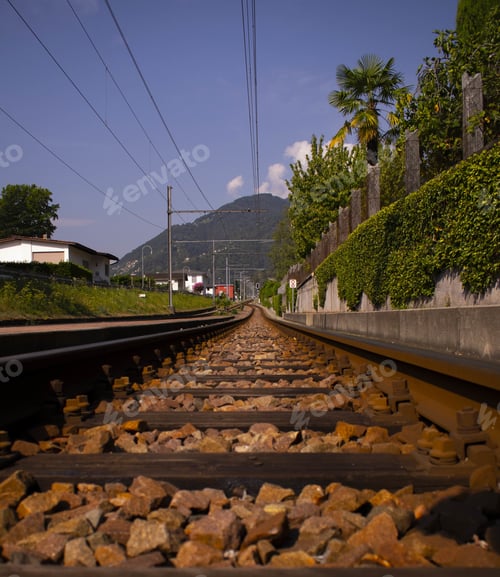 Preview: Vertical shot of a railway track in the middle of the town
