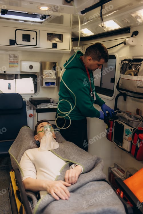 Preview: paramedic healthcare emergency staff taking care of a lying down young woman patient on stretcher