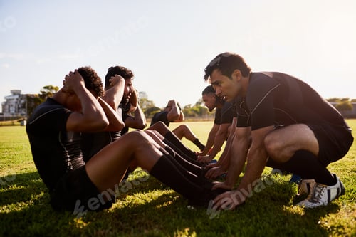 Preview: Full length shot of a diverse group of sportsmen training during a rugby practice in a sports club