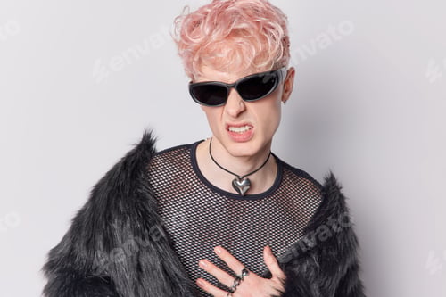 Preview: Handsome man with trnedy pink hairstyle clenches teeth has annoyed expression wears trendy