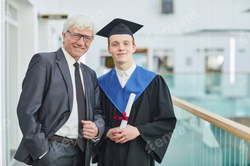 Preview: Young man posing with professor at graduation ceremony