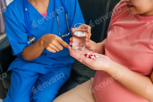 Preview: Asian doctor and nurse use ultrasound and stethoscope to address hypertension with pregnant woman.