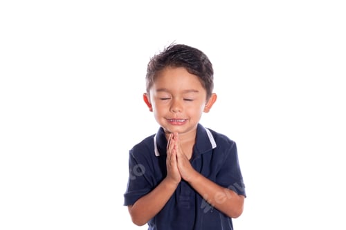 Preview: Boy asking for forgiveness with closed eyes. Latin boy joins hands while praying in front of camera.