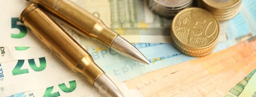 Preview: Yellow cartridges and shell casings on euro banknotes. Lot of bills of European union currency