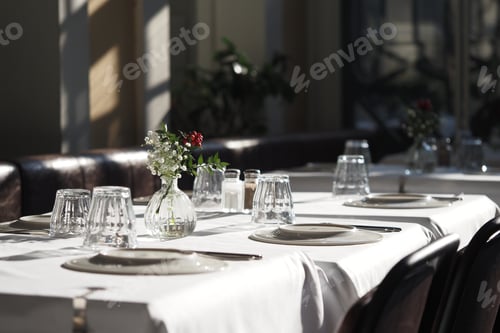 Preview: Elegant dining setup at a restaurant with natural sunlight