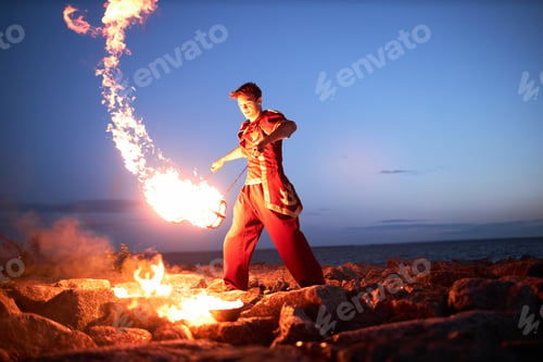 Preview: Young man juggling fire poi