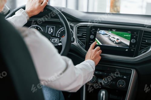 Preview: Driving a car. Woman is in autosalon at daytime
