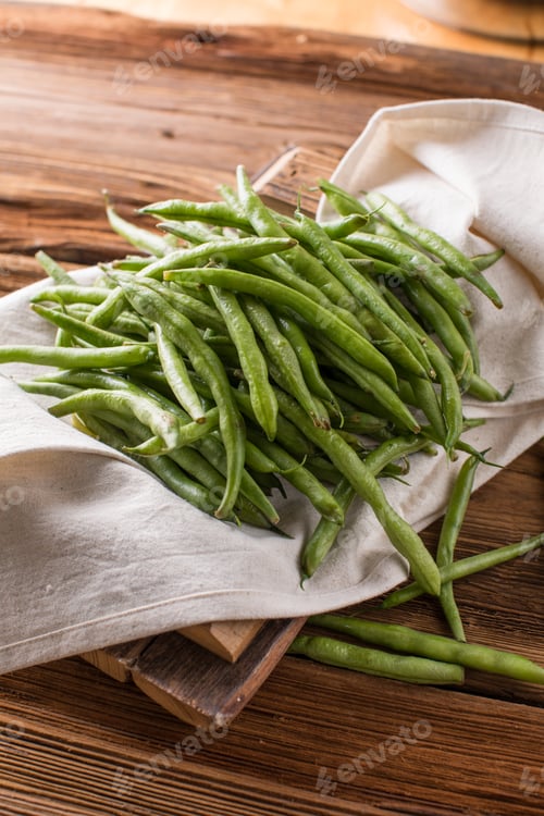Preview: Fresh young beans pods. Old wooden background. Green string beans crop conception