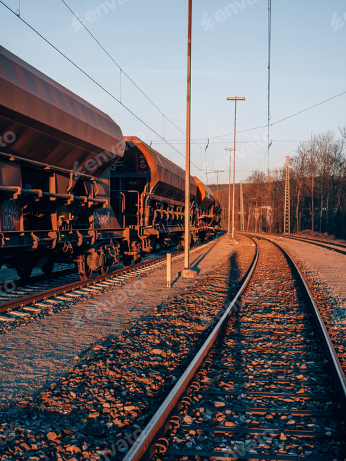 Preview: Cargo train on railways at sunset