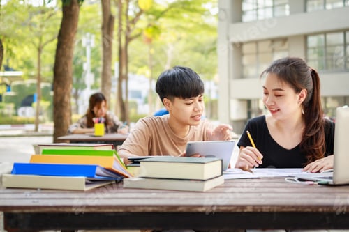Preview: Students Working Together on Campus at Wooden Table