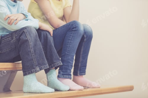 Preview: happy children which are sitting on the stairs in the house.