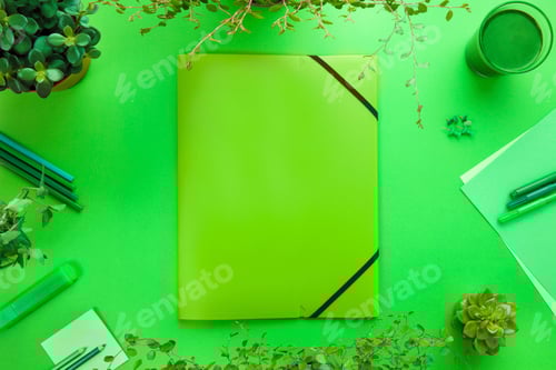 Preview: Green Concept of a Folder And Office Supplies On Desk