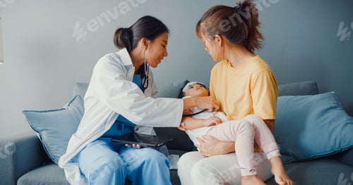 Preview: Asia female pediatrician hold stethoscope exam little girl patient visit doctor with mother.