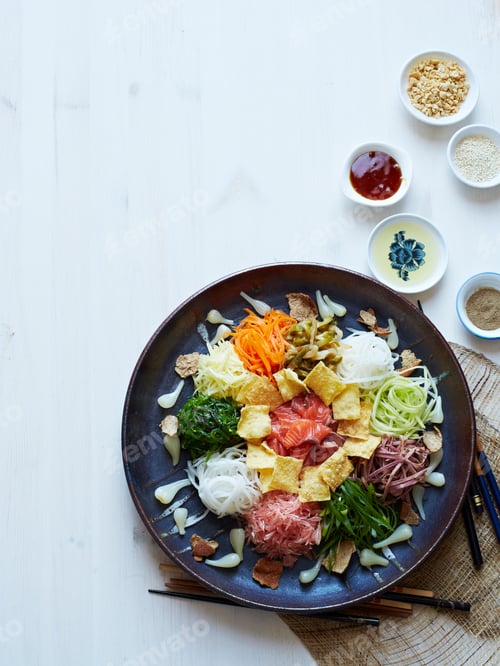 Preview: A colorful Korean bibimbap dish on a table with sauces.