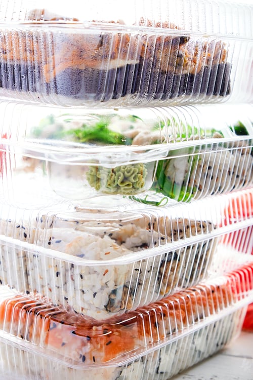 Preview: Stack of plastic boxes with sushi roll sets. Food delivery