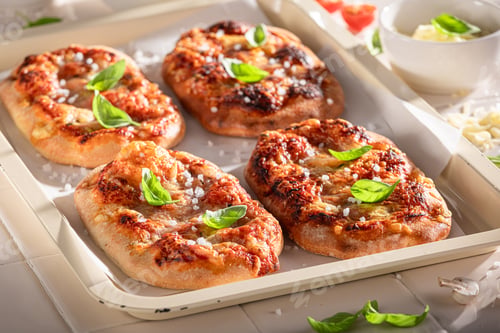 Preview: Healthy pinsa Margherita served with olive oil and basil.