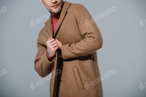 Preview: cropped view of fashionable man posing in beige coat, isolated on grey
