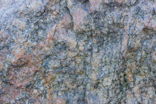 Preview: Granite Texture Close Up. Granite Rocks With Porous Surface. Background From Solid Stone. Pattern
