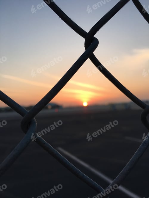 Preview: Beautiful sunset as seen from a chain link fence