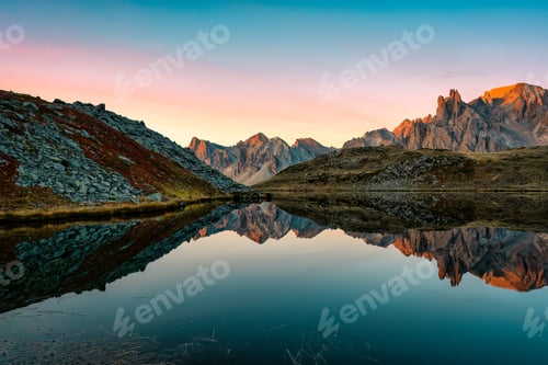 Preview: Lac Long with massif Des Cerces reflection on the lake during autumn in Claree valley
