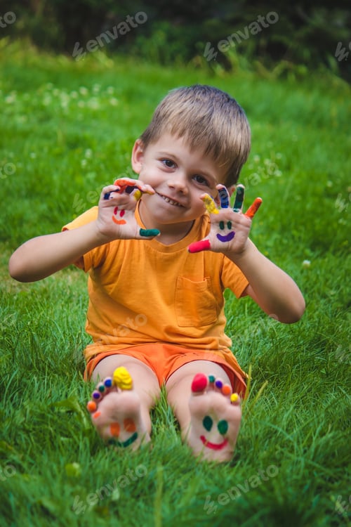 Preview: Children's hands in the colors of summer, a smile on the boy's palm.