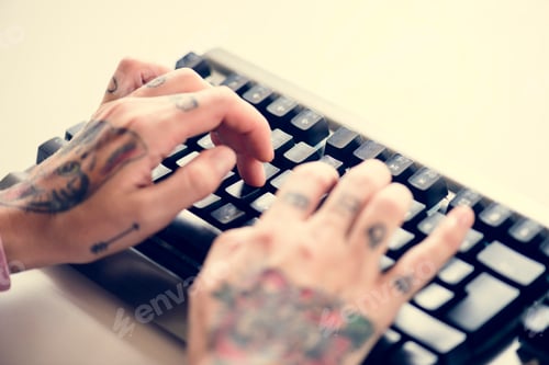 Preview: Hands with tattoo typing on a keyboard
