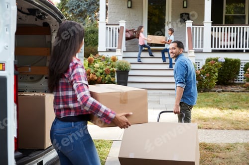Preview: Children Helping Unload Boxes From Van On Family Moving In Day