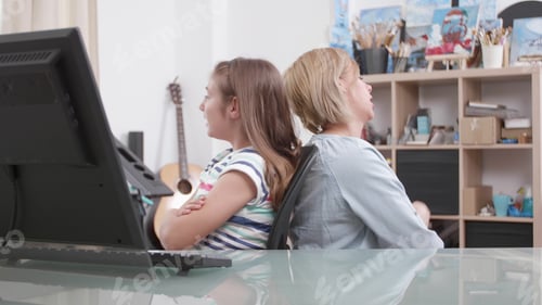 Preview: Mother and daughter standing back to back arguing for school grades