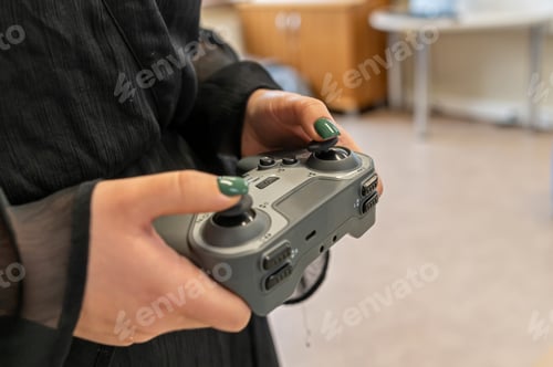 Preview: Robot controller in hands of a user in a modern technology environment