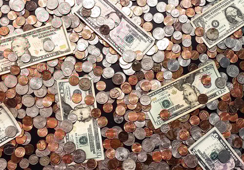 Preview: A retired man's life savings of coins and bills on table counted to plan ahead for future.