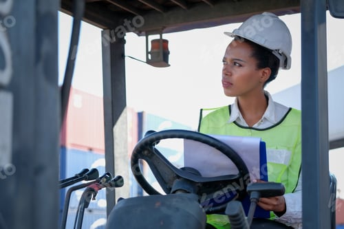 Preview: African technician worker woman stay on tractor and look to some directions and action of thinking