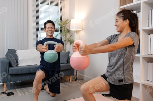 Preview: A young couple exercising together at home, smiling and enjoying their workout routine.