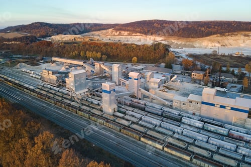 Preview: Aerial view of cargo train loaded with crushed sandstone materials at mine factory.