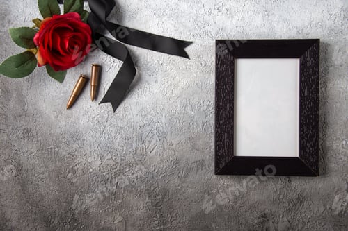 Preview: top view of picture frame with red flower and bullets on the white background death tank war