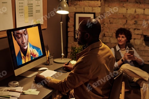 Preview: Graphic designer working on computer with graphic tablet